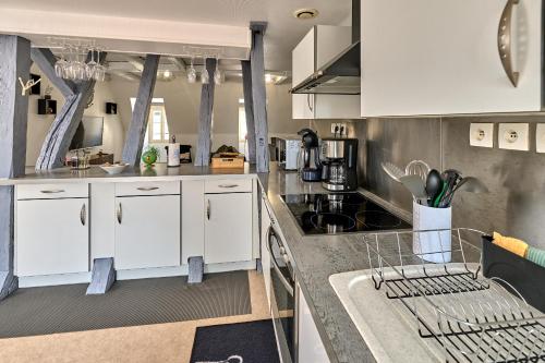 a kitchen with white cabinets and a counter top at Appartement de caractère, charme in Nevers