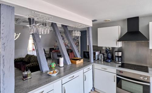 a kitchen with white cabinets and a stove top oven at Appartement de caractère, charme in Nevers