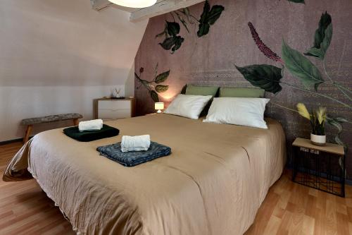 a bedroom with a large bed with two pillows on it at Appartement de caractère, charme in Nevers