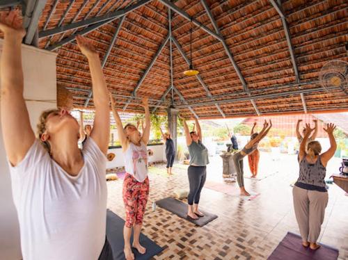 a group of people doing yoga in a gym at La Lune Fort Kochi in Cochin
