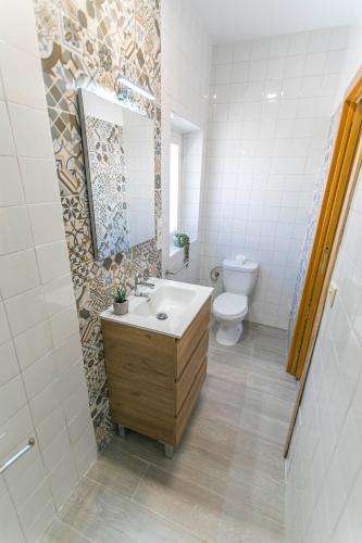 a bathroom with a sink and a toilet at Embrujo Andaluz Complejo Rural Órgiva in Órgiva