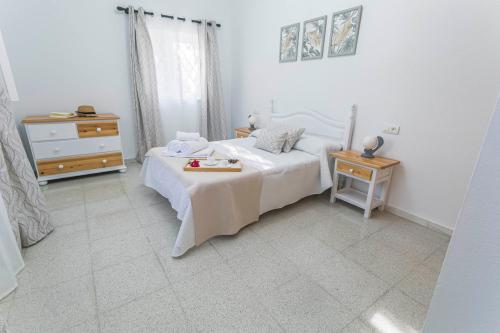 a bedroom with a white bed and a nightstand and a bed sidx sidx sidx at Embrujo Andaluz Complejo Rural Órgiva in Órgiva