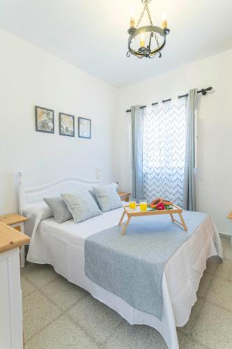 a bedroom with two beds with a table on top of them at Embrujo Andaluz Complejo Rural Órgiva in Órgiva