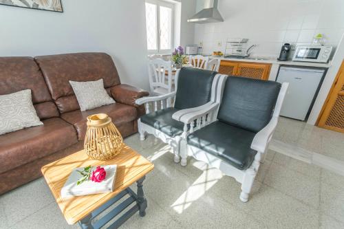 a living room with a couch and two chairs and a table at Embrujo Andaluz Complejo Rural Órgiva in Órgiva