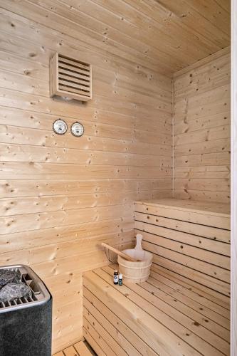 a wooden sauna with two clocks on the wall at Shishly Palace Hotel in Istanbul
