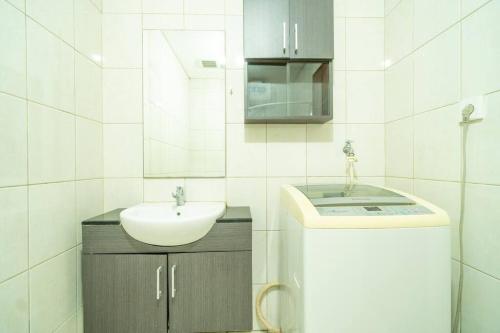 a white bathroom with a sink and a mirror at Peaceful studio in central Jakarta, SCBD, Thamrin in Jakarta