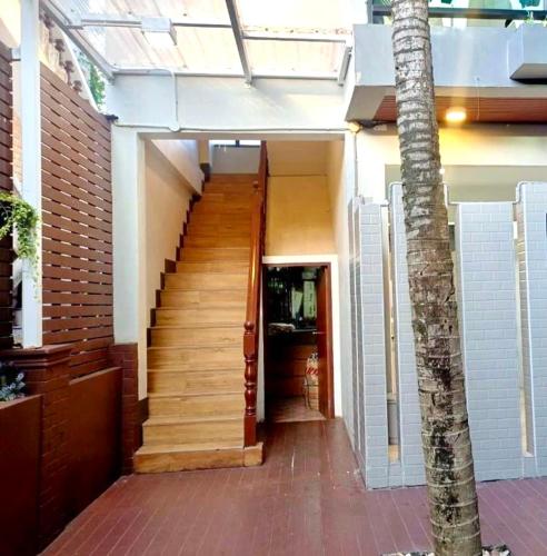 a staircase leading to a building with a stair case at Kata Noi Bay Inn in Kata Beach