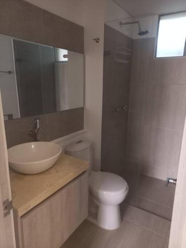 a bathroom with a sink and a toilet and a mirror at Apartamento Ámbar Villeta in Villeta
