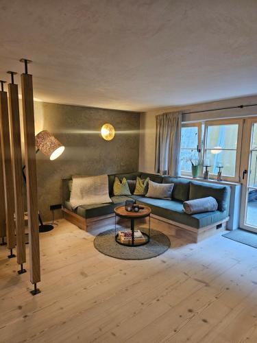 a living room with a couch and a table at Chalet zur Auszeit in Mittenwald