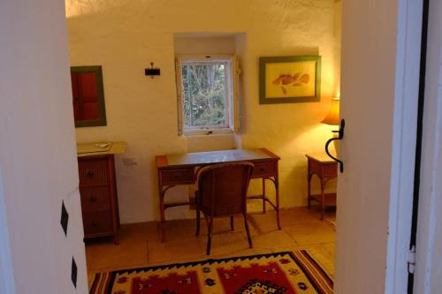 a kitchen with a table and chairs and a window at Casa Palma Gozo in Għarb