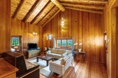 a living room with a couch and a tv at La Libellula in Scopello