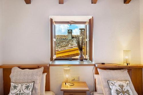 a room with a window with a view of a city at Chalet de montaña con vistas in Prullans