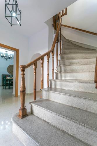a stairway in a home with a chandelier at Embrujo Andaluz Complejo Rural Órgiva in Órgiva