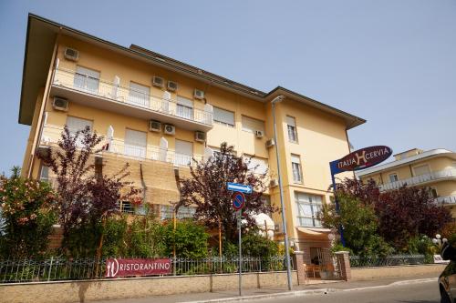 a large building on the side of a street at Hotel ITALIACERVIA in Cervia