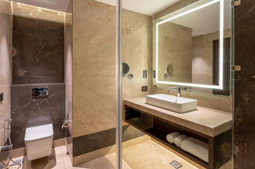 a bathroom with a sink and a shower at Grand Mirage Dhanbad, a member of Radisson Individuals in Dhanbād