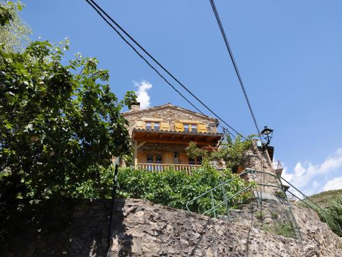 a house sitting on top of a rock at Chalet de montaña con vistas in Prullans