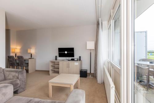 TV a/nebo společenská místnost v ubytování Fletcher Wellness-Hotel Kamperduinen