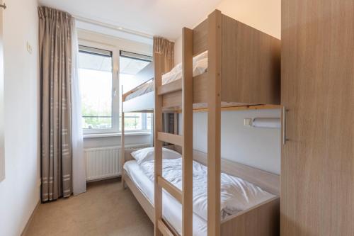 Postel nebo postele na pokoji v ubytování Fletcher Wellness-Hotel Kamperduinen