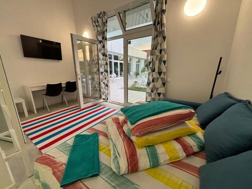 a bedroom with a bed with colorful pillows on it at Fantastic camp in Piteşti