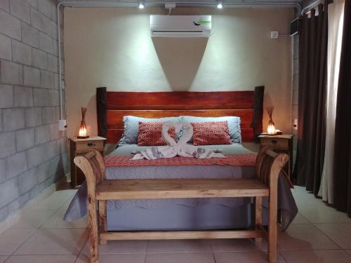 a bedroom with a bed with a bow on it at Nelumbo Petit Chalet in San Rafael
