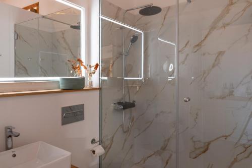 a bathroom with a shower with a glass door at La Casa de La Camelia in La Laguna