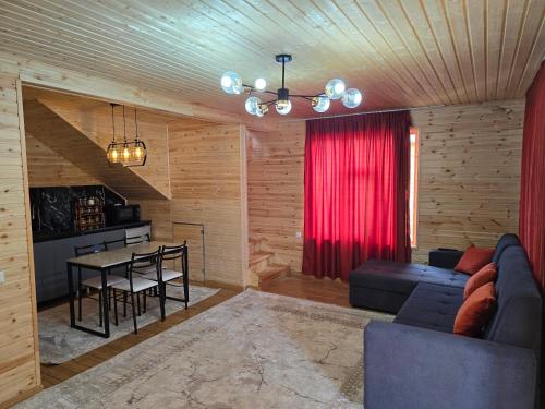 a living room with a couch and a table at Wood House 2 in Bosteri