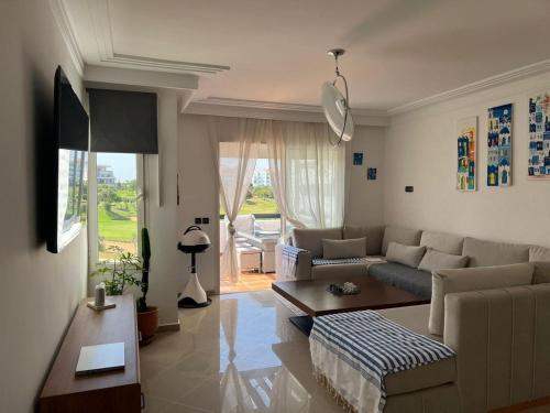 a living room with a couch and a table at chez badr in Asilah