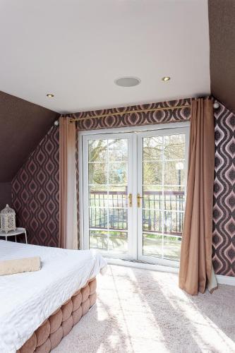 a bedroom with a bed and a large window at Brig O'Doon 1 in Ayr