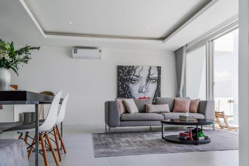 a living room with a couch and a table at The Beach Residence in Koh Samui 