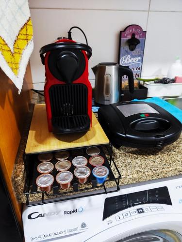 a kitchen counter with a tea kettle and cupcakes at Flor da Providência in Viseu