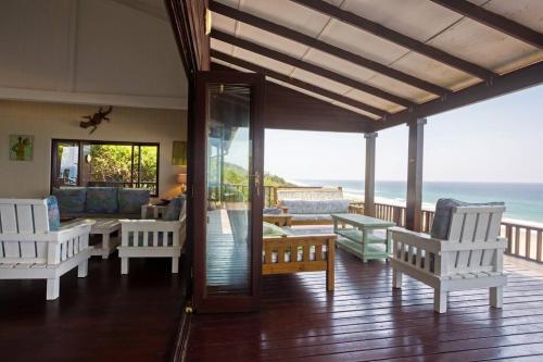 a living room with a view of the ocean at Mar Azul 5 in Ponta Malongane