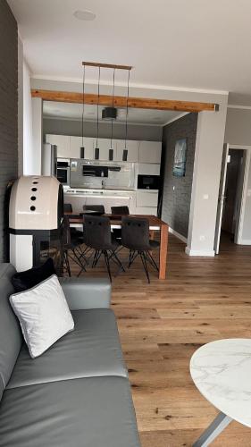 a living room with a couch and a dining table at Winkelschiffchen II mit Sauna in Juist