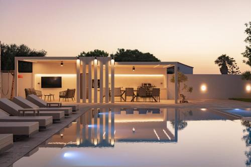 a villa with a swimming pool and a house at Elia Villa, with Pool, SeaViews & Iconic Design, By ThinkVilla in Astérion