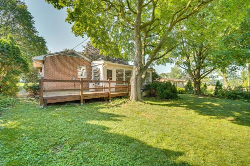 a home with a large yard with a wooden deck at Movie Room and Home Gym Sinking Spring Home! in Sinking Spring