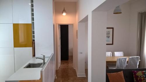 a kitchen and dining room with a sink and a table at Alex Home in Lisbon