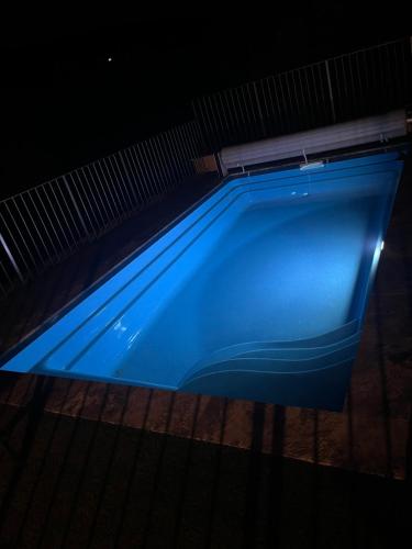 a blue swimming pool in a dark room at villa'nduzienne in Anduze