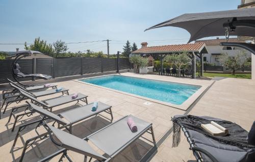 a group of chairs and a swimming pool at Villa Mia in Frata