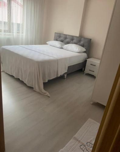 a bedroom with a large bed with white sheets at Ecemsuit5 in Yomra