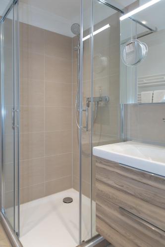 a shower with a glass door in a bathroom at Nordwind in Westerland