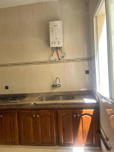 a kitchen with a sink and a window at 2 Chaaban 1, 1136 in Larache