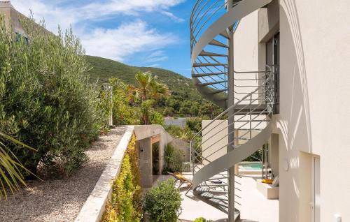 a spiral staircase on the side of a house at Gorgeous Home In Vis With Sauna in Vis