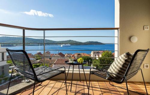 two chairs and a table on a balcony with a view at Gorgeous Home In Vis With Sauna in Vis