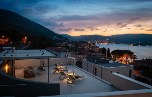 a balcony with a view of a city at dusk at Gorgeous Home In Vis With Sauna in Vis