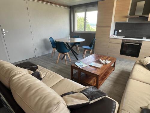 a living room with a couch and a table at MonacellA in Nonette