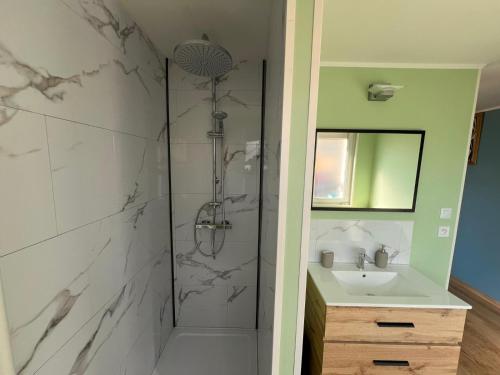 a bathroom with a shower and a sink at MonacellA in Nonette