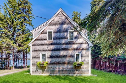 a house with two windows and two flower boxes at Driftwood in Glenmere