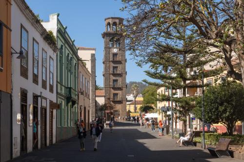 a city street with a clock tower in the distance at La Casa de La Camelia in La Laguna