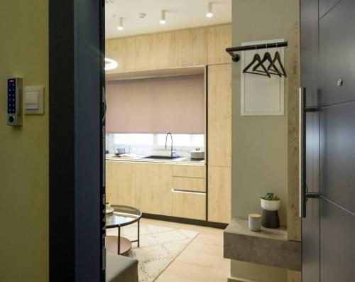 a kitchen with a refrigerator and a table at Aristotelian Virtues - Elpida in Thessaloniki