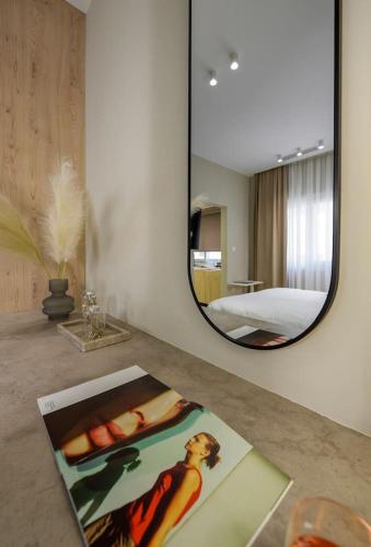 a mirror on a counter in a room with a bed at Aristotelian Virtues - Elpida in Thessaloniki