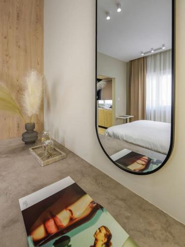 a mirror on a counter in a bedroom with a bed at Aristotelian Virtues - Elpida in Thessaloniki